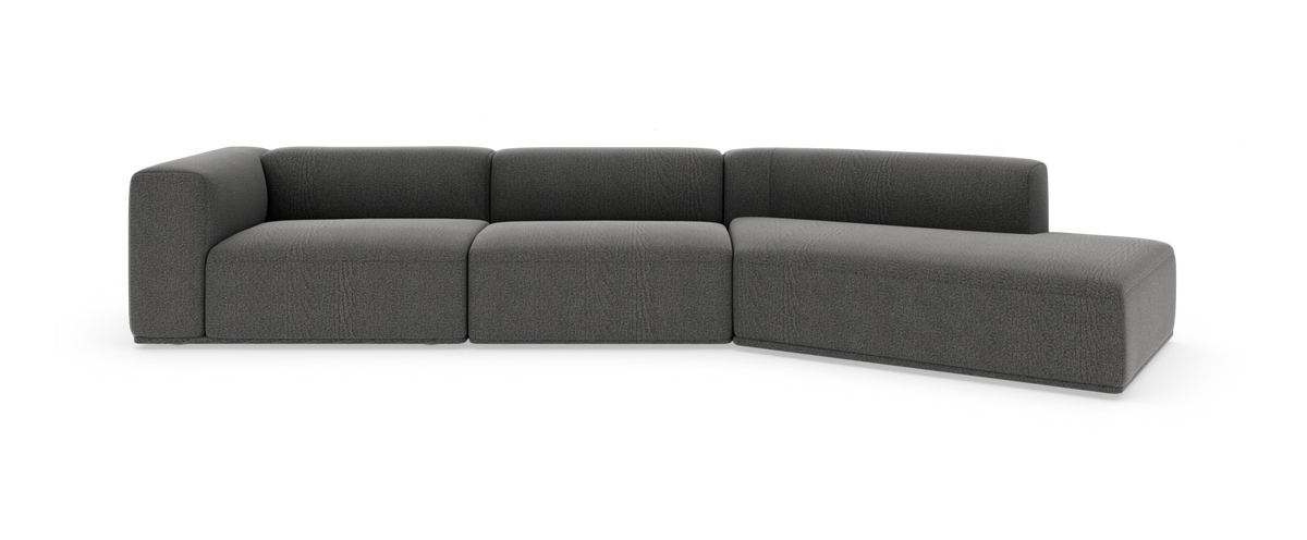 Mørkegrå modulsofa med højre chaiselong på hvid studiobaggrund.