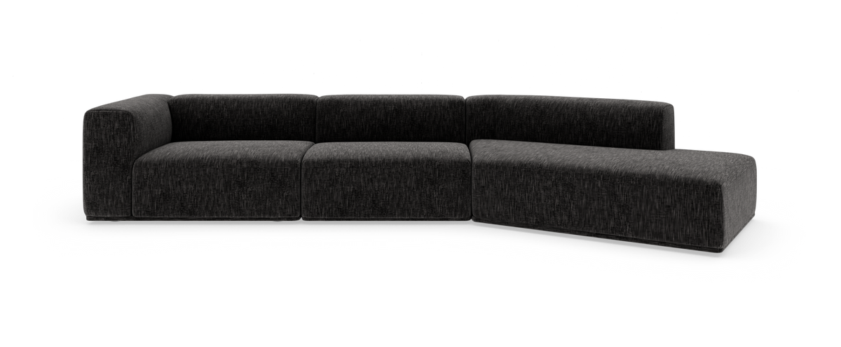 Mørkegrå modulsofa i L‑form med chaiselong til højre, fritlagt på hvid baggrund.