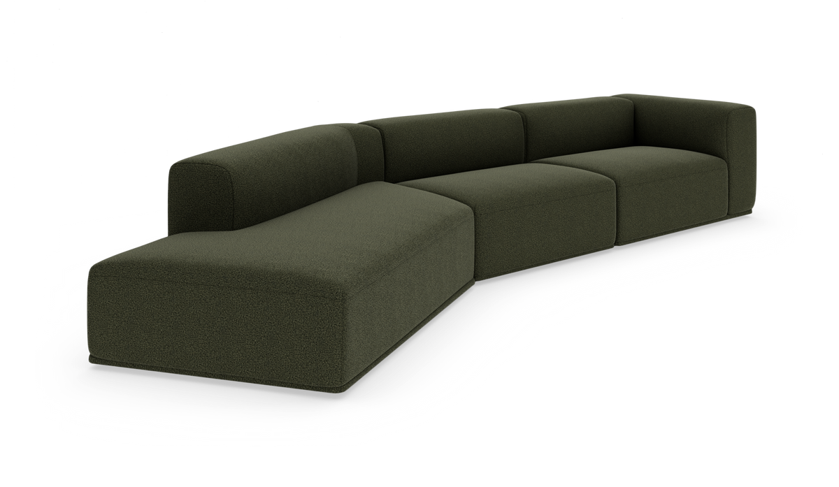 Mørkegrøn modulsofa med afrundede hjørner i tekstil, vist i skrå frontvinkel på hvid baggrund.