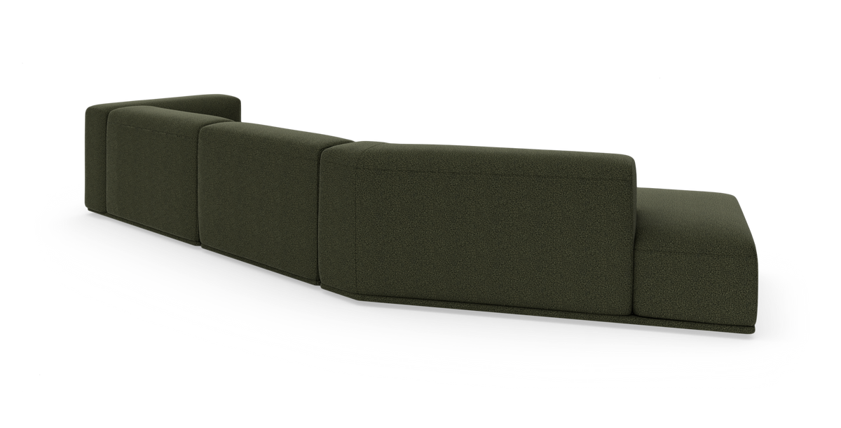 Mørkegrøn modulsofa set bagfra på hvid baggrund.
