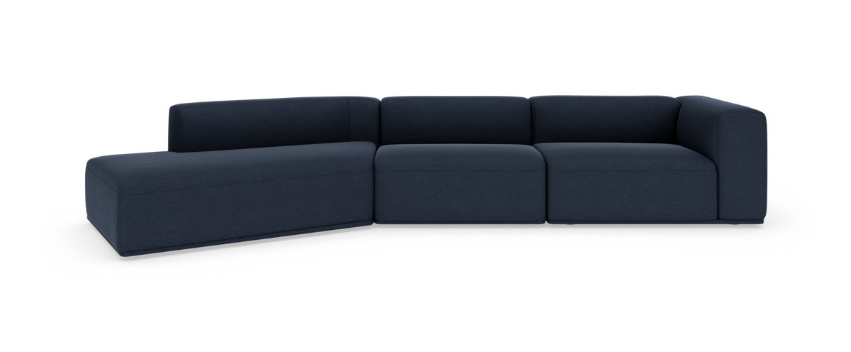 Mørkeblå modulsofa i L‑form på hvid baggrund.