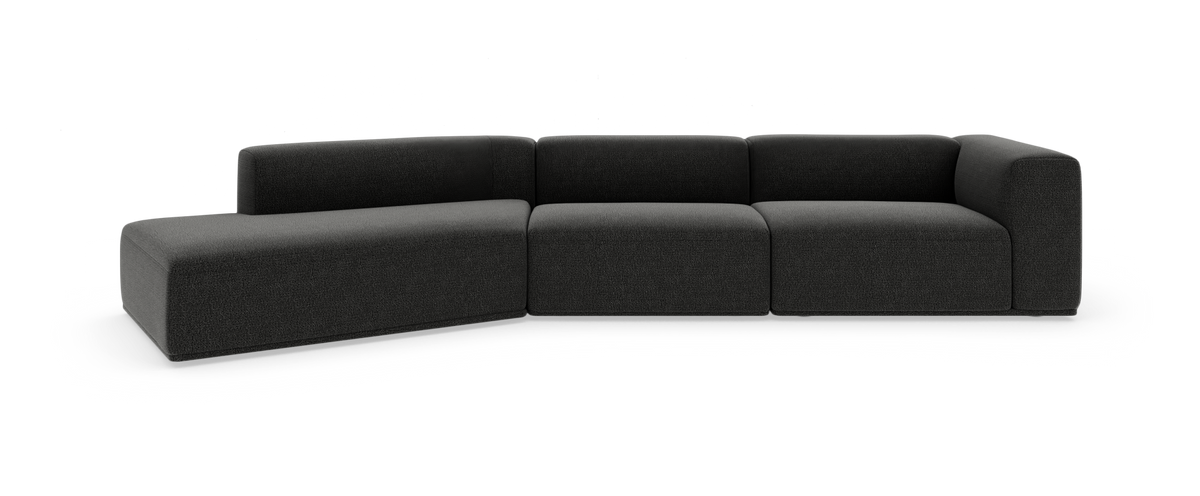 Mørkegrå modulsofa i L‑form på hvid baggrund.