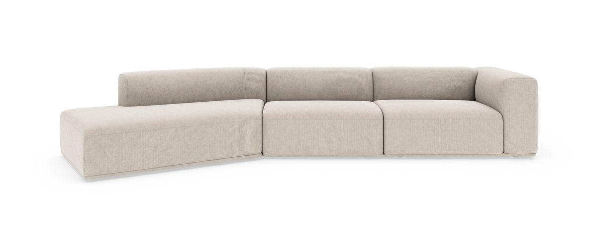 Beige modulsofa med venstre chaiselong og afrundede armlæn, fritstående på hvid baggrund.