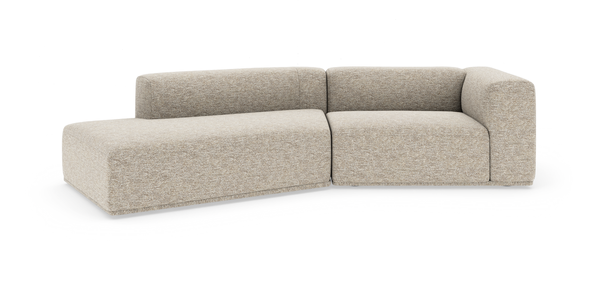 Lys beige modulsofa i L‑form med afrundede hjørner på hvid studiobaggrund.