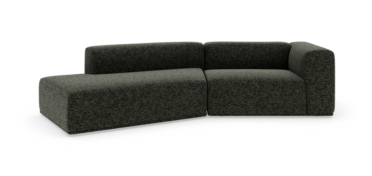 Mørkegrå modulsofa i L‑form på hvid studiobaggrund.