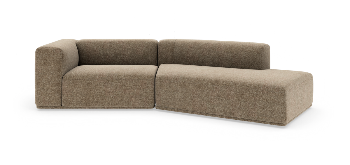 L‑formet modulsofa i beige stof med højrevendt chaiselong, bløde afrundede hjørner og lav ryg – frilagt på hvid baggrund.