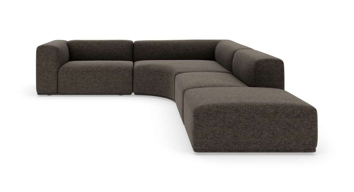 Modulær L-formet sofa i mørkegråt stof med afrundede hjørner og lav profil.