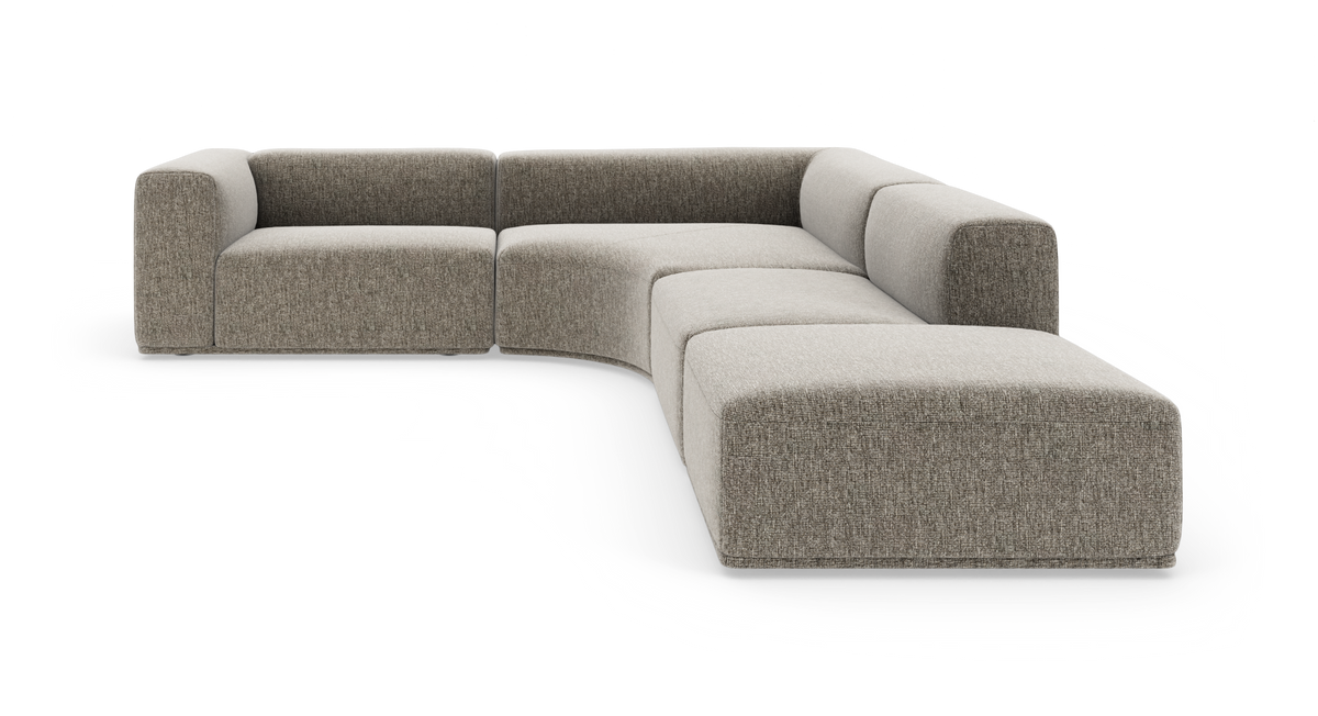 Modulær L-sofa i gråbeige stof med afrundede hjørner og lav profil, frilagt på hvid baggrund.
