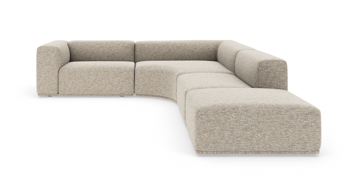 Modulær L‑formet hjørnesofa i beige tekstil med afrundede moduler, frilagt på hvid baggrund.