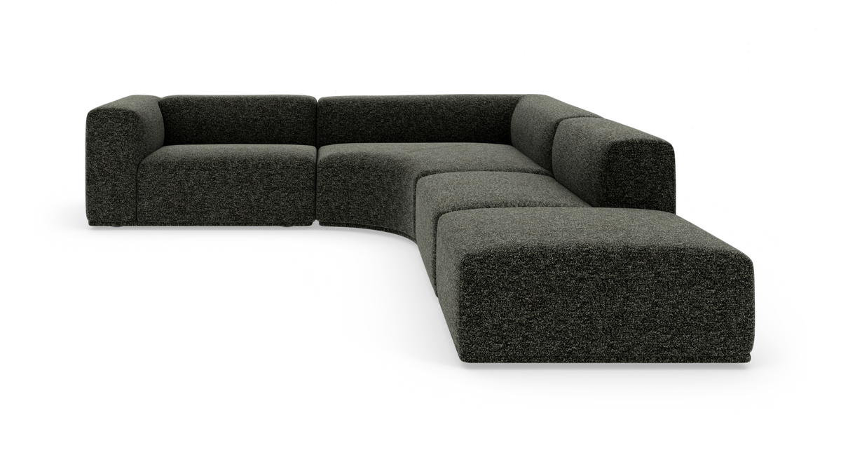 Mørkegrå modulsofa i L-form med afrundet midtersektion, fritstående på hvid baggrund.