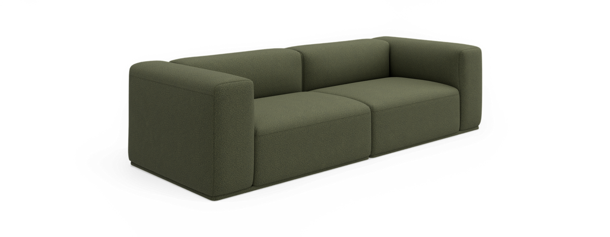 Grøn modulsofa med afrundede hjørner i moderne, minimalistisk design, frilagt på sort baggrund.
