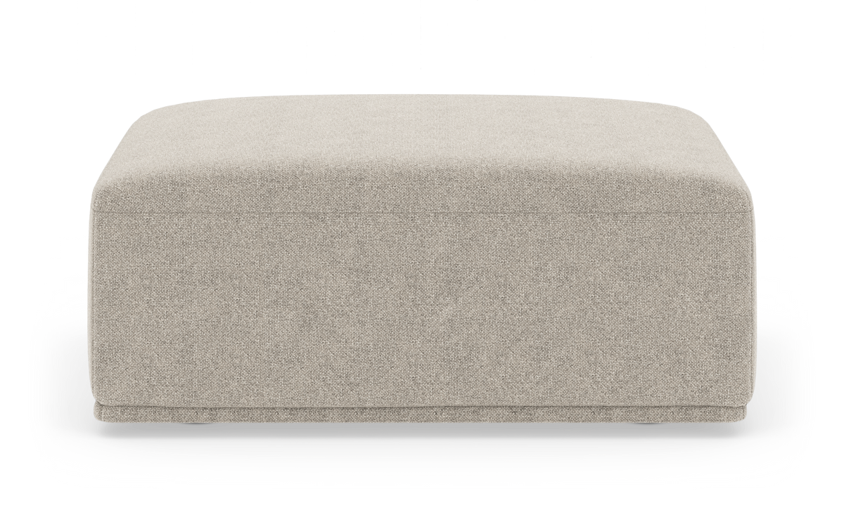 Beige kvadratisk puff/ottoman i stof på hvid baggrund.