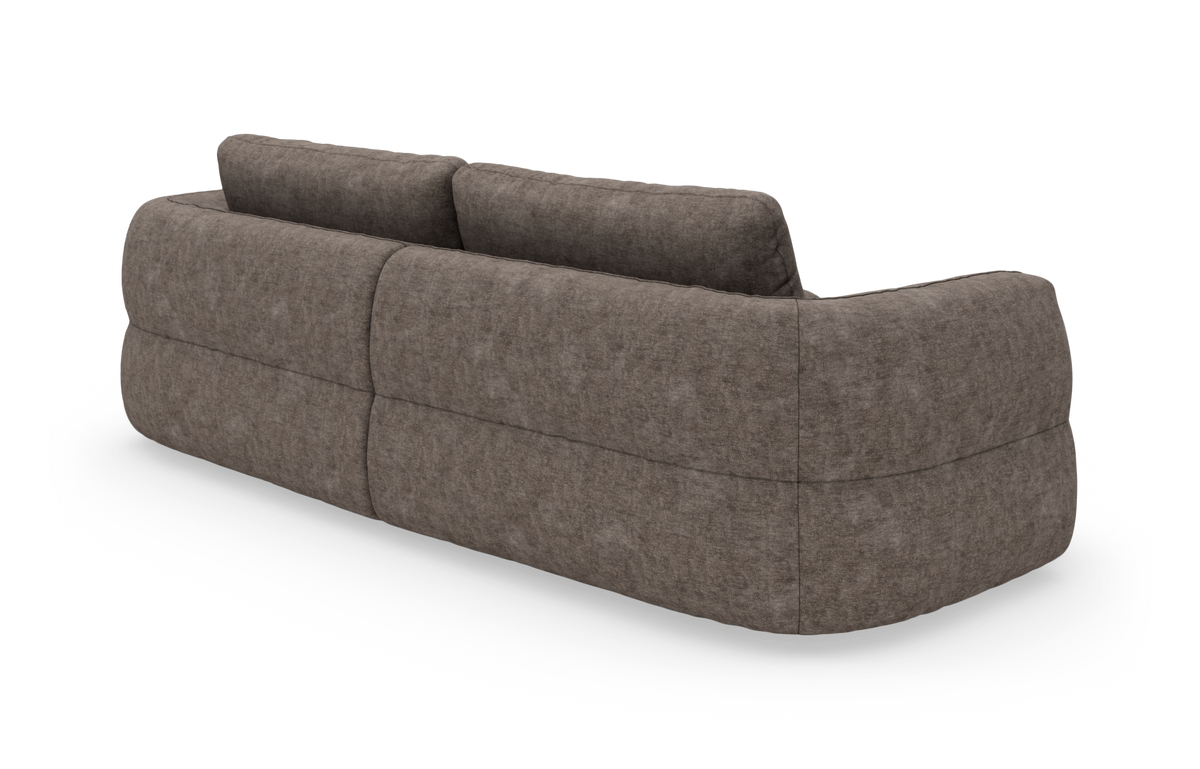 Brungrå modulsofa set bagfra i studieopsætning med afrundede former og blød polstring.