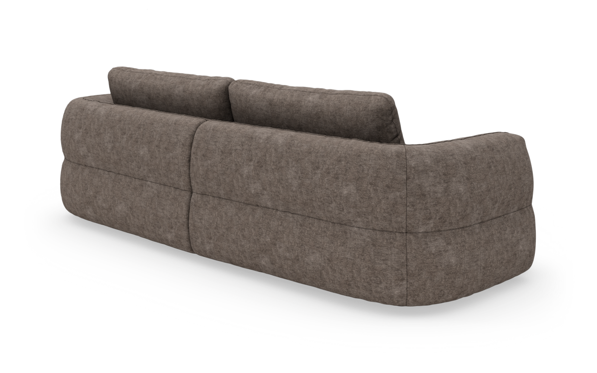 Brungrå, rundet modulsofa set skråt bagfra på hvid baggrund.